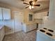 Kitchen with white cabinets, appliances, and tile floor at 1937 N Spring Garden Ave, Deland, FL 32720