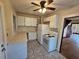 White kitchen with appliances and access to other rooms at 1937 N Spring Garden Ave, Deland, FL 32720