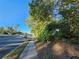 Roadside view of property with sidewalk and mature trees at 1937 N Spring Garden Ave, Deland, FL 32720