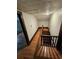 Upstairs hallway with hardwood floors and access to bedrooms at 1937 N Spring Garden Ave, Deland, FL 32720