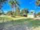 Spacious backyard with a lush lawn, mature trees, and a storage shed at 2040 N Nemo Dr, Deltona, FL 32725