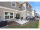 Private backyard patio with rocking chairs and mature trees at 2353 Carrabelle Way, Sanford, FL 32771