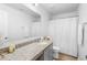 Modern bathroom with granite countertop, gray vanity, and white shower curtain at 2353 Carrabelle Way, Sanford, FL 32771