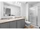 Double vanity bathroom with granite countertops and shower at 2353 Carrabelle Way, Sanford, FL 32771