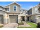 Modern two-story townhome with attached garage and landscaped walkway at 2353 Carrabelle Way, Sanford, FL 32771