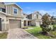 Townhouse exterior with gray siding and a paved driveway at 2353 Carrabelle Way, Sanford, FL 32771