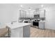 Modern gray kitchen with stainless steel appliances and quartz countertops at 2353 Carrabelle Way, Sanford, FL 32771