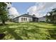 Spacious backyard with lush lawn and screened patio at 2423 Wild Turkey Creek Ln, Port Orange, FL 32128