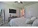 Bright bedroom with a TV, double doors, and en-suite bathroom access at 2423 Wild Turkey Creek Ln, Port Orange, FL 32128