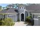 Gray exterior with a unique turret and a paved driveway at 2423 Wild Turkey Creek Ln, Port Orange, FL 32128