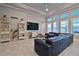 Living area with sectional sofa, large TV, and built-in shelving at 2423 Wild Turkey Creek Ln, Port Orange, FL 32128