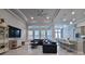 Open living space with a sectional sofa and a large TV at 2423 Wild Turkey Creek Ln, Port Orange, FL 32128