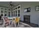 Screened porch with seating area and fireplace at 2423 Wild Turkey Creek Ln, Port Orange, FL 32128