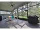 Spacious screened porch with outdoor furniture and grill at 2423 Wild Turkey Creek Ln, Port Orange, FL 32128