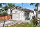 Quaint bungalow home with a single car garage and established landscaping at 243 Lexington Dr, Daytona Beach, FL 32114