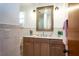 Bathroom with light wood cabinets and a large mirror at 25 Valhalla Ave, Ormond Beach, FL 32176