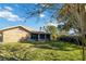 Landscaped backyard showcasing a brick house with a screened patio at 2501 Alton Rd, Deltona, FL 32738