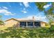 Brick house with a large screened porch and grassy backyard at 2501 Alton Rd, Deltona, FL 32738
