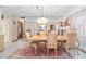 Elegant dining room with chandelier and mirrored wall at 2501 Alton Rd, Deltona, FL 32738