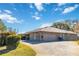 Brick home showcasing side view and attached garage at 2501 Alton Rd, Deltona, FL 32738