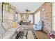 Relaxing sunroom featuring comfortable furniture and brick walls at 2501 Alton Rd, Deltona, FL 32738