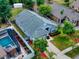Aerial view shows house, pool, and surrounding neighborhood at 2911 Wild Pepper Ave, Deltona, FL 32725