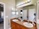 Double vanity bathroom with a large mirror and access to bedroom at 2911 Wild Pepper Ave, Deltona, FL 32725
