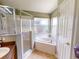 Bathroom features a shower and garden tub at 2911 Wild Pepper Ave, Deltona, FL 32725