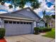 Gray house with a two-car garage and nicely manicured lawn at 2911 Wild Pepper Ave, Deltona, FL 32725