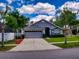 Gray one-story house with a two-car garage and landscaped yard at 2911 Wild Pepper Ave, Deltona, FL 32725