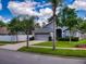 One-story house with gray siding, palm trees, and a two-car garage at 2911 Wild Pepper Ave, Deltona, FL 32725