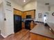 Well-equipped kitchen with dark wood cabinets and black appliances at 2911 Wild Pepper Ave, Deltona, FL 32725
