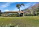 Brick house with palm tree and well-manicured lawn at 2994 Annez Way, Debary, FL 32713