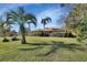 Well-manicured lawn with multiple palms creating stunning curb appeal at 2994 Annez Way, Debary, FL 32713
