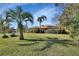 Ranch-style home with a lush lawn and palm trees at 2994 Annez Way, Debary, FL 32713