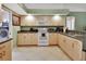 Modern kitchen featuring white appliances and wood cabinets at 2994 Annez Way, Debary, FL 32713