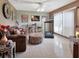 Living room with tiled floor, brown couch, and treadmill at 2994 Annez Way, Debary, FL 32713