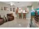 Living room with kitchen bar, TV, and recliners at 2994 Annez Way, Debary, FL 32713