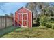 Red storage shed in the backyard provides extra storage at 2994 Annez Way, Debary, FL 32713