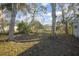 Spacious backyard with mature trees and a partially visible shed at 3164 Chamberlain St, Deltona, FL 32738