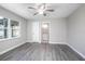 Bright bedroom with grey flooring, ceiling fan, and view of the backyard at 3164 Chamberlain St, Deltona, FL 32738