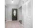 Inviting entryway with tile flooring, coat closet, and elegant front door at 3164 Chamberlain St, Deltona, FL 32738