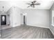 Open living space with gray walls, vinyl flooring, and a ceiling fan at 3164 Chamberlain St, Deltona, FL 32738