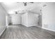 Spacious living room with gray vinyl flooring and a ceiling fan at 3164 Chamberlain St, Deltona, FL 32738