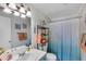 Clean bathroom with a teal vanity and shower/tub combo at 3509 S Atlantic Ave # 301, New Smyrna Beach, FL 32169