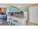 Modern kitchen with light blue cabinets, granite countertops, and breakfast bar at 3509 S Atlantic Ave # 301, New Smyrna Beach, FL 32169