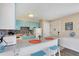 Charming kitchen with light blue cabinets, granite countertops, and modern appliances at 3509 S Atlantic Ave # 301, New Smyrna Beach, FL 32169