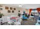 Bright living room features stylish seating, dining table, and access to balcony with ocean views at 3509 S Atlantic Ave # 301, New Smyrna Beach, FL 32169
