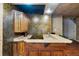 Basement wet bar with granite countertop and wooden cabinetry at 3548 Tuscany Reserve Blvd, New Smyrna Beach, FL 32168