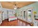 Bright bedroom with wood floors and access to a private balcony at 3548 Tuscany Reserve Blvd, New Smyrna Beach, FL 32168